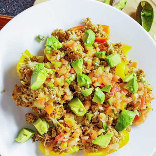 Healthy nachos made with Bell pepper crispy chips topped with taco meat, salsa, cheese and avocado